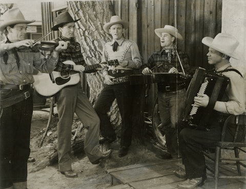 Johnny Bond (second from left) and Jimmy Wakely (center) playing together with three unidentified men.