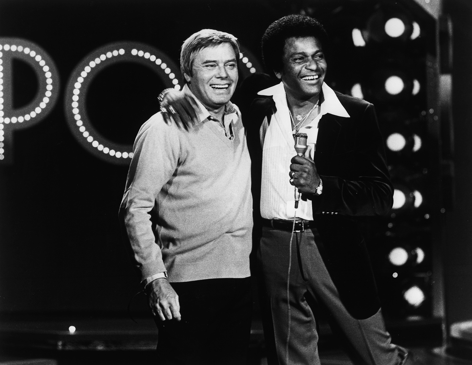 Charley Pride appearing on the television series Pop! Goes the Country, with host Tom T. Hall, c. 1980.