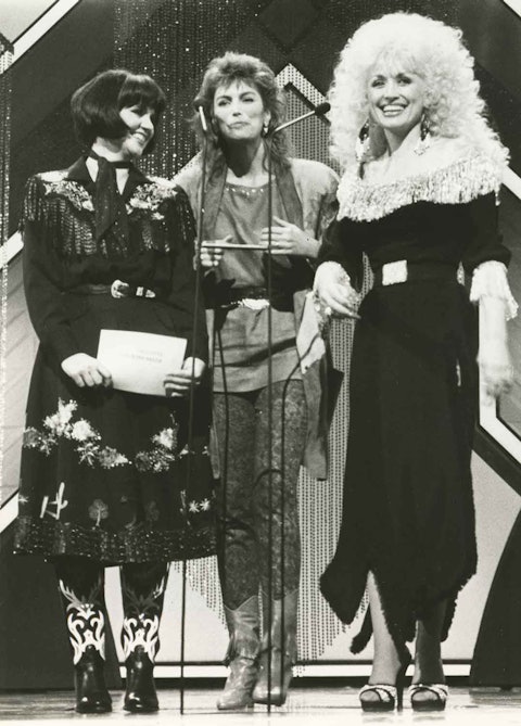 Linda Ronstadt, Emmylou Harris, and Dolly Parton appear as the Trio at the CMA Awards in October 1986. Photo by Alan L. Mayor.