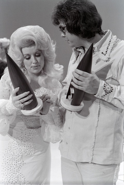 Dolly Parton and Ronnie Milsap holding their 1975 CMA awards. She won Female Vocalist and he won Album of the Year for A Legend in My Time. Photo by Raeanne Rubenstein.