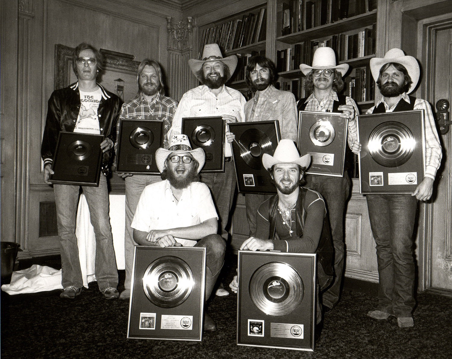 Charlie Daniels Band accepting gold and platinum records at the 21 Club in New York City, 1979. Back row, from left: Charlie Hayward, Fred Edwards, Charlie Daniels, Jim Marshall, unidentified, tour manager David Corlew. Front row, from left: Tommy Crain and Don Murray.