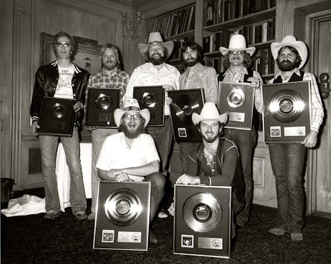 Charlie Daniels Band accepting gold and platinum records at the 21 Club in New York City, 1979. Back row, from left: Charlie Hayward, Fred Edwards, Charlie Daniels, Jim Marshall, unidentified, tour manager David Corlew. Front row, from left: Tommy Crain and Don Murray.