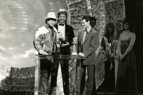 From left: Songwriter Paul Overstreet, music publisher Cliff Audretch, and Randy Travis at the 22nd Annual ACM Awards in April 1987. The group accepted the award for Song of the Year for Travis's recording of 