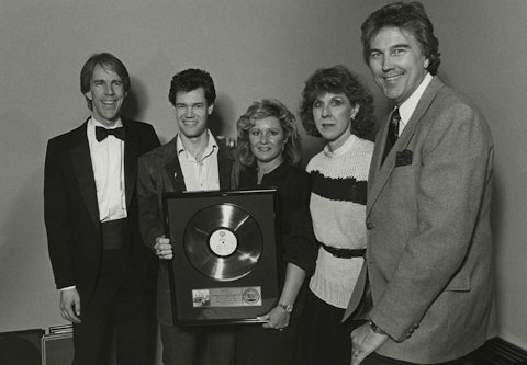 Randy Travis receives a platinum record award in 1987 for sales of 1 million copies for his debut album, Storms of Life. Left to right: Warner Bros. Executive VP, Jim Ed Norman, Randy Travis, ASCAP Southern Director Connie Bradley, Warner Bros. VP of A&R, Martha Sharpe, and ASCAP Associate Director Merlin Littlefield.