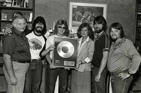 Jerry Bradley (far left) and BMI’s Frances Preston present Alabama (from left: Randy Owen, Mark Herndon, Teddy Gentry, and Jeff Cook) with a gold record award signifying sales of 500,000 copies of their album Feels So Right, June 1981.