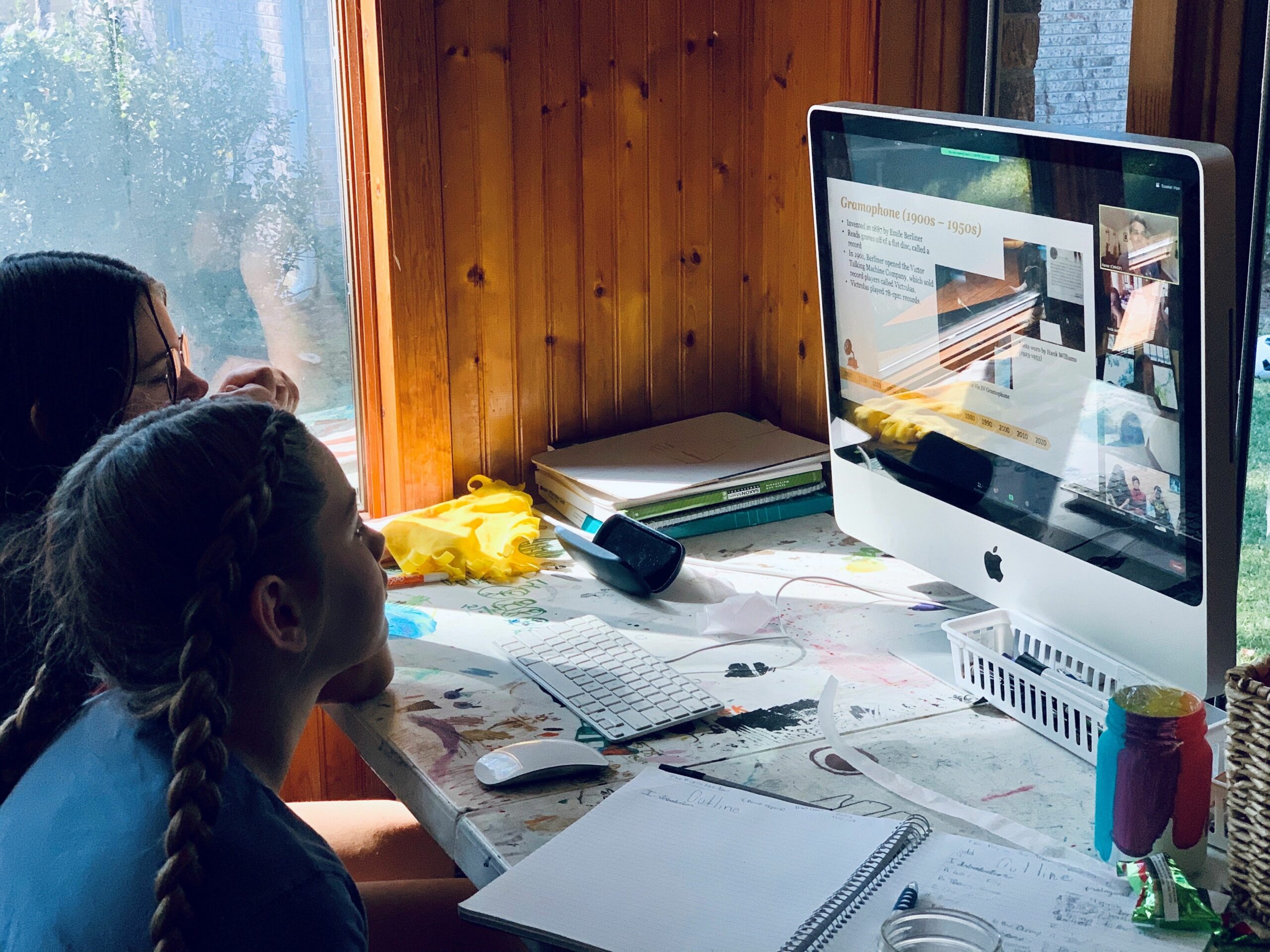 Photo of two homeschooled students watching a virtual lesson online.