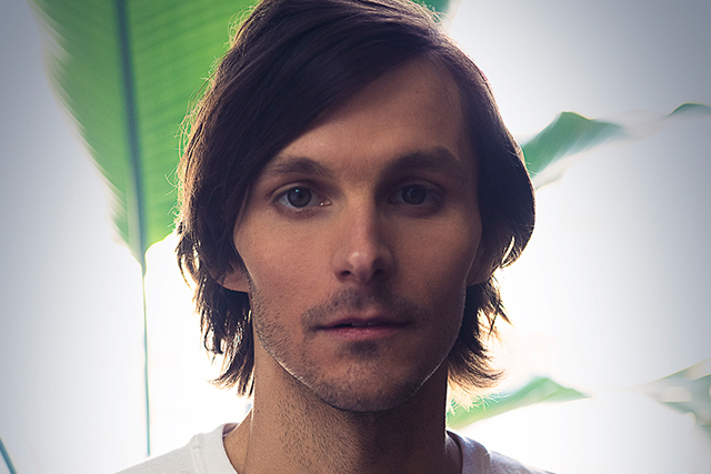 Photo of Charlie Worsham in front of a plant.