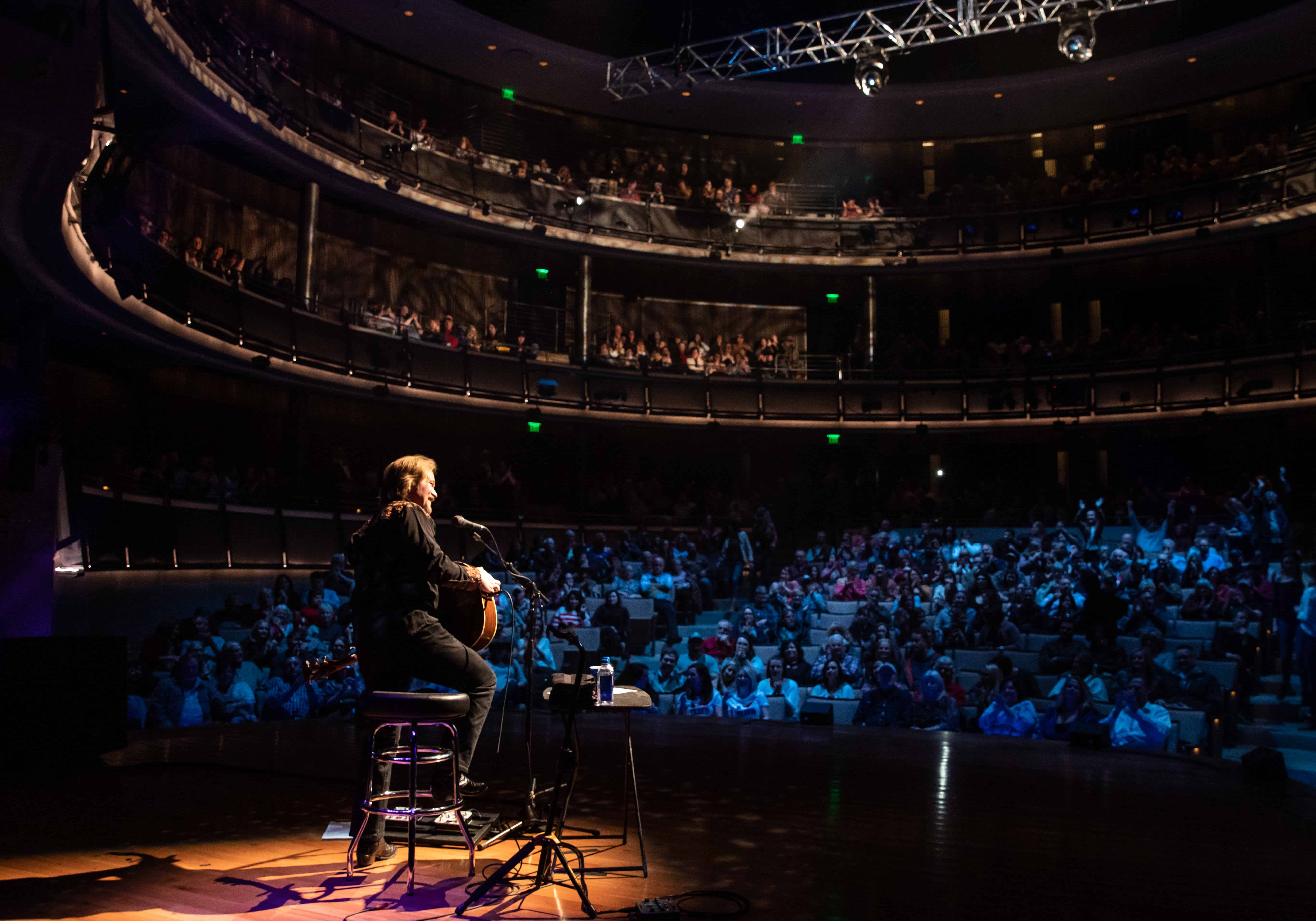 Travis Tritt sing to a crowd in the CMA theater.