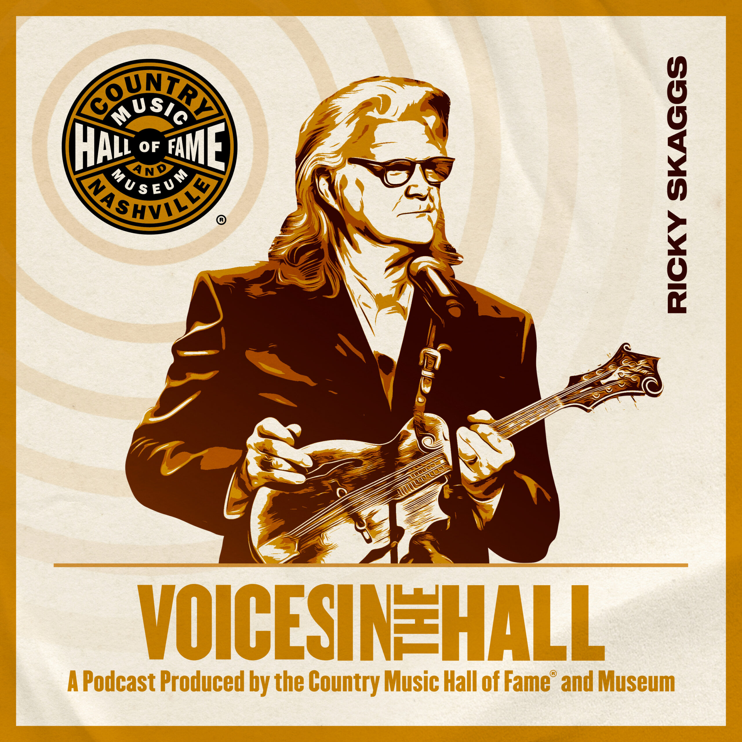 S1E4: Ricky Scaggs on Country Music Hall of Fame and Museum’s “Voice in the Hall” Podcast. Scaggs is in a sleek blazer with beautiful, long silver hair wearing thick-rimmed black glasses. He is holding a fiddle in front of a microphone.