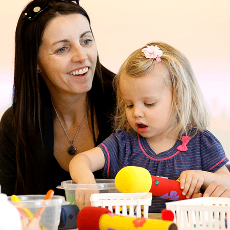 Creative Zone: Adorn A Microphone. Photo of a mother and child with toy microphones.