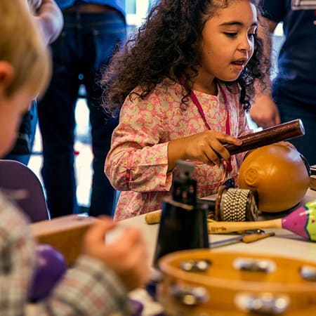 Photo of children playing with various musical instruments.