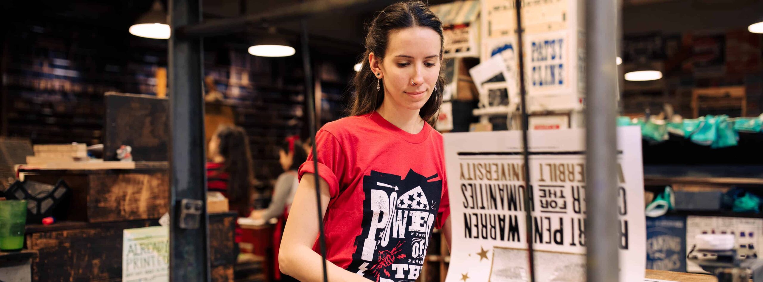 Hatch Show Print Watch & Listen: Meet Your Maker. Photo of designer-printer working in the studio.