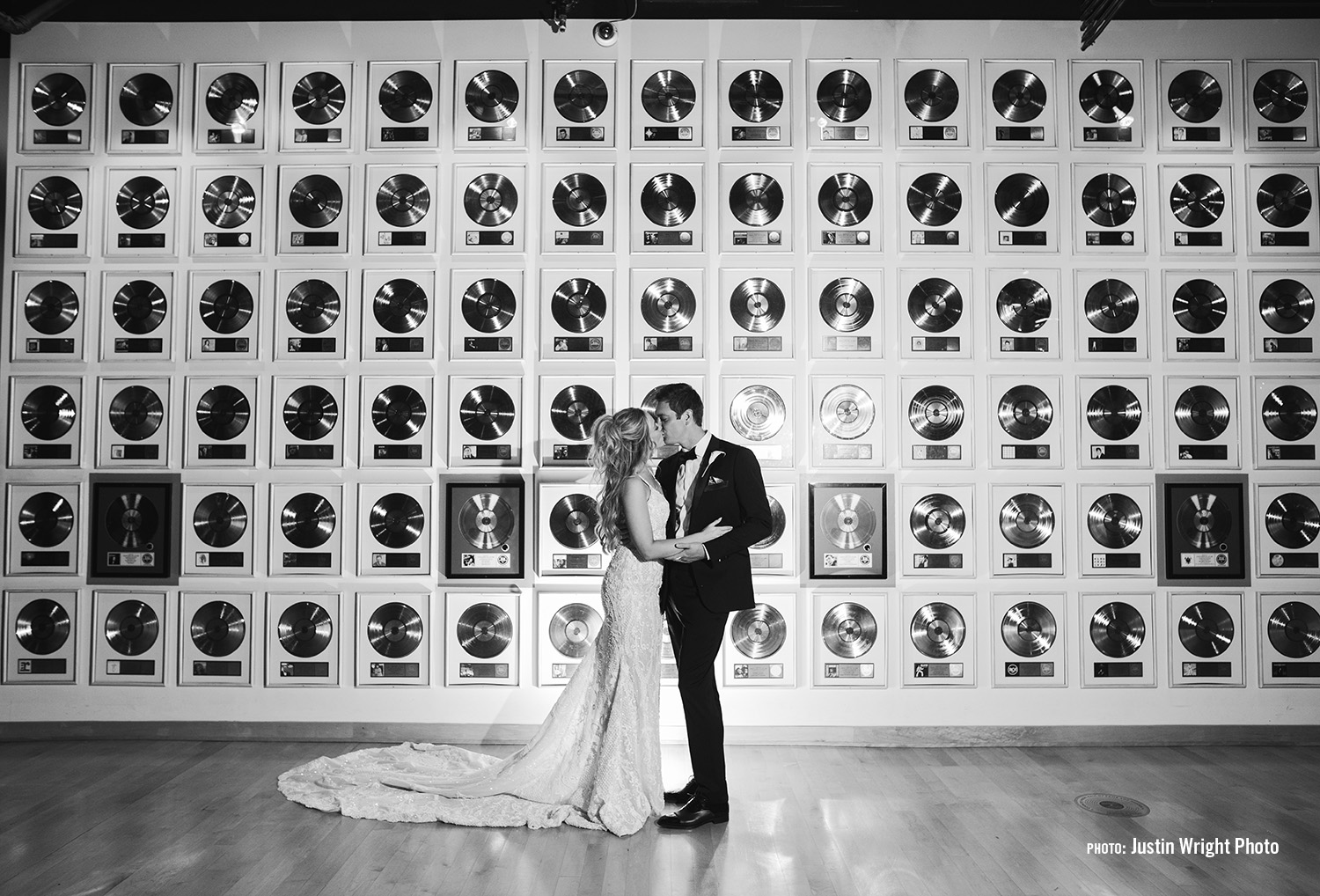 Married couple standing in front of the record wall in the Country Music Hall of Fame and Museum a Downtown Nashville Event Venue