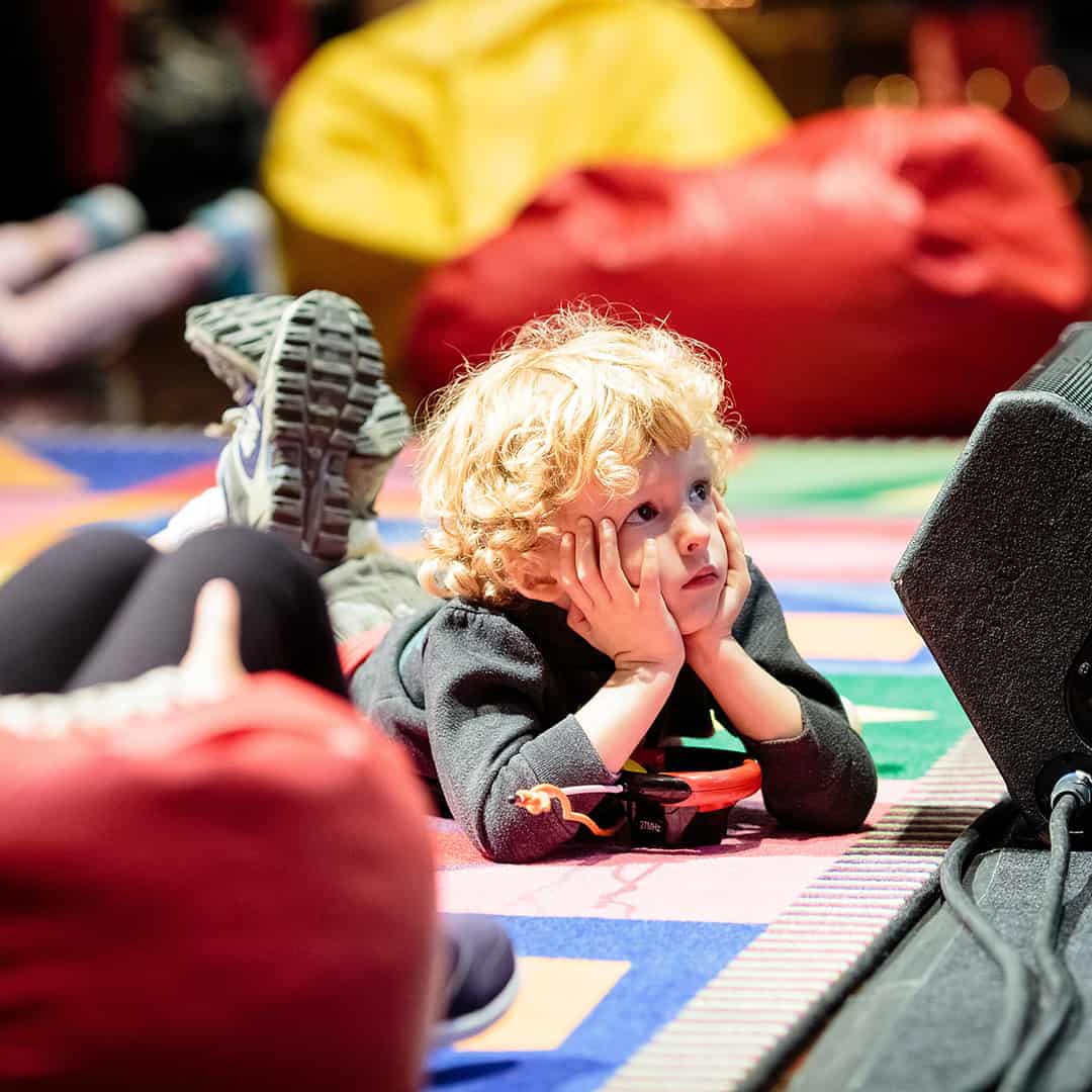boy on carpet observing