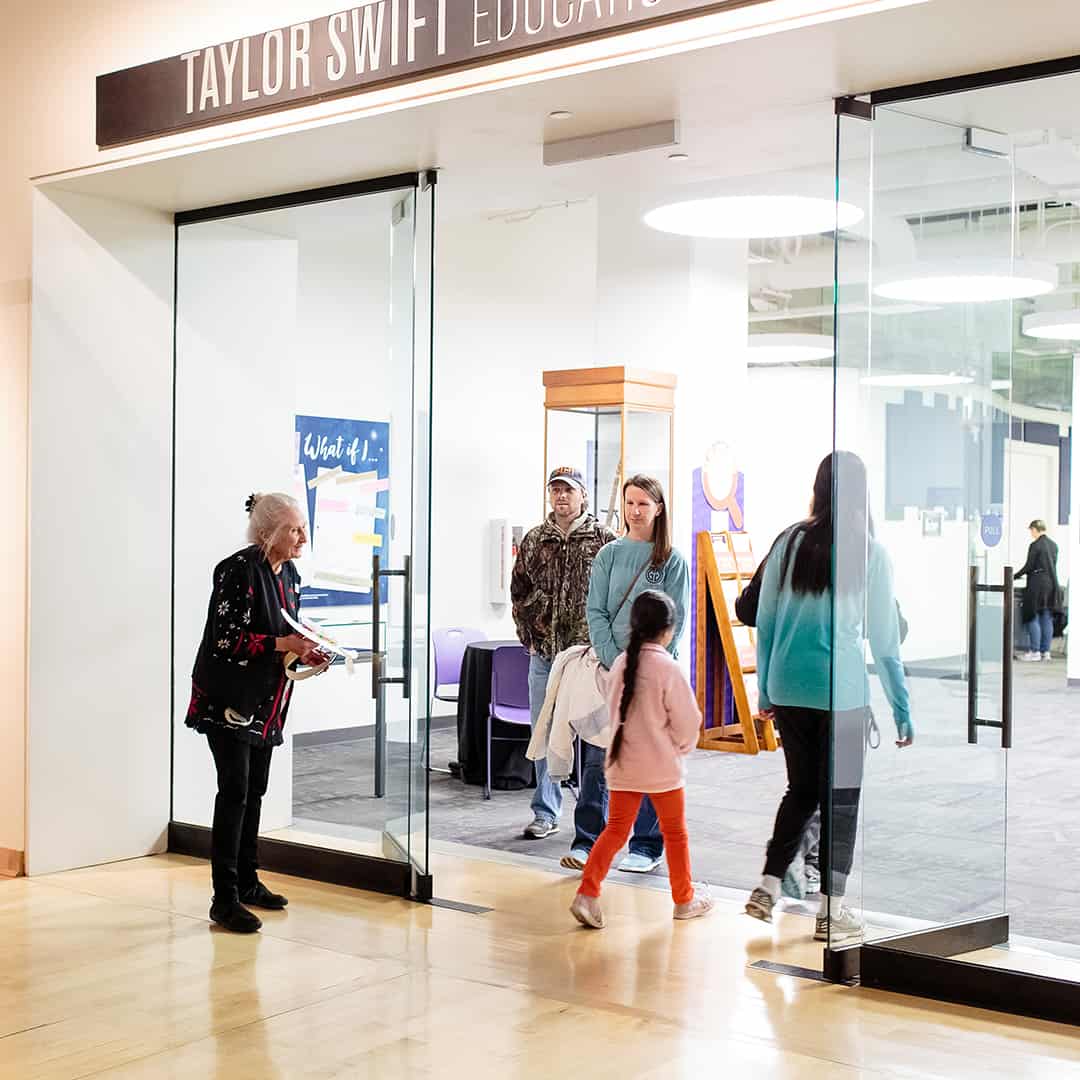 A group of people walking into the Taylor Swift Education Center, taylor swift nashville museum, educational things to do in nashville