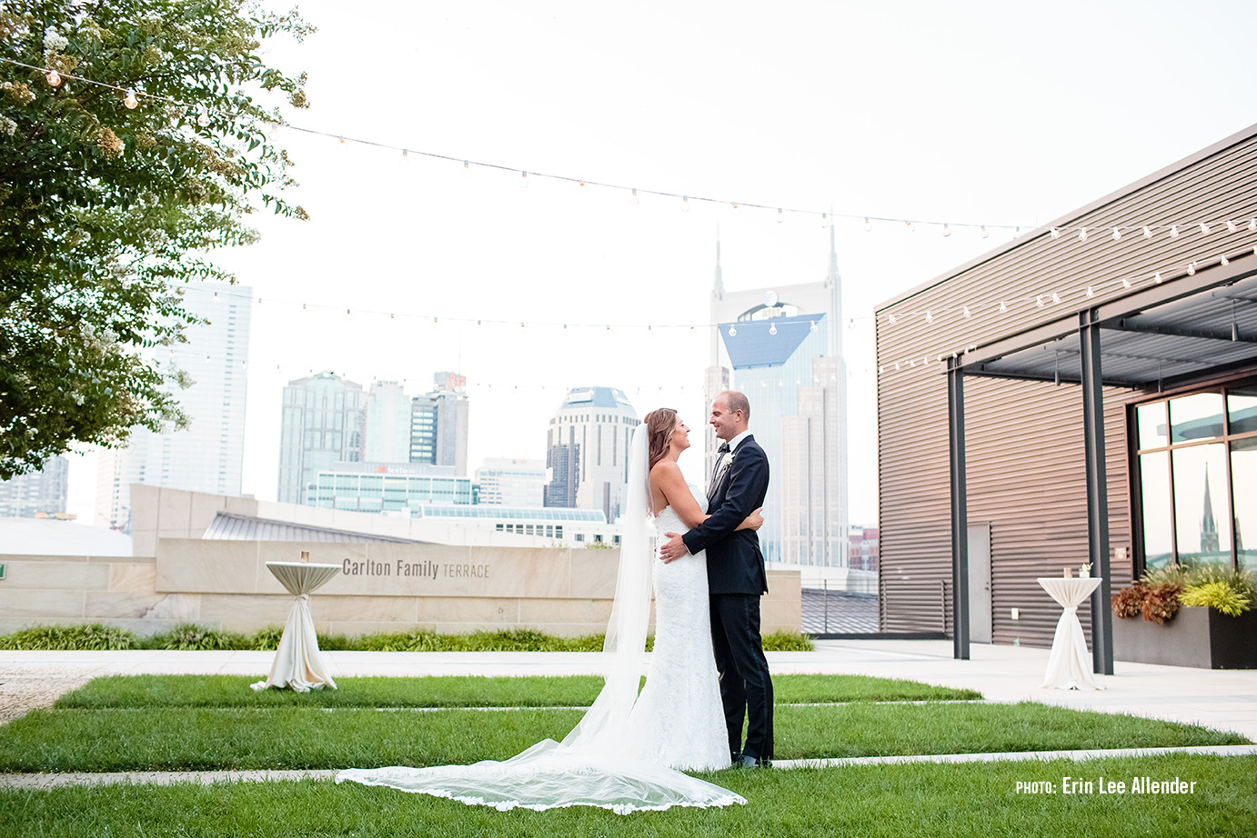Couple embraces on rooftop terrace enjoying the downtown Nashville wedding venue