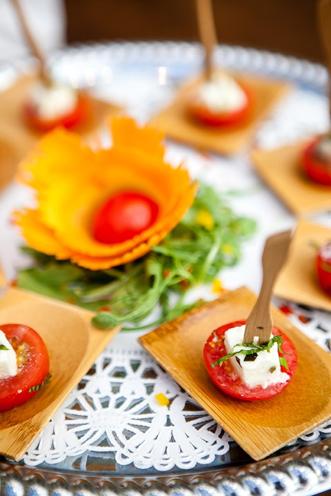 gourmet catering appetizers on a large serving plate with white decorative napkins underneath