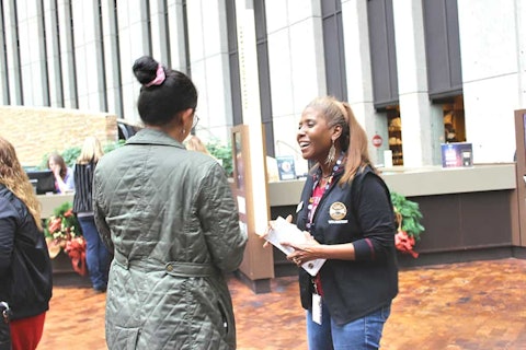 Volunteer speaking with a guest with a smile