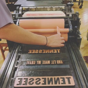 Hands working with custom carved blocks