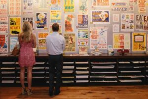 People looking at a wall of posters