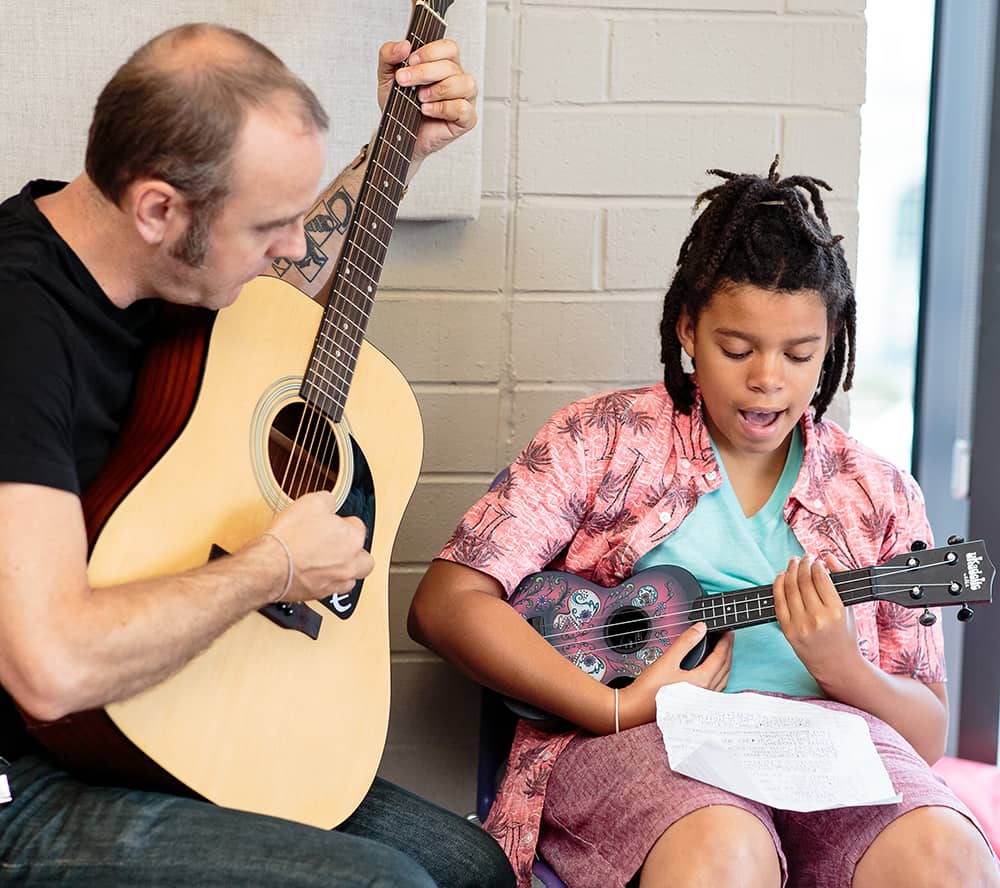 Man and boy with guitar and ukelele