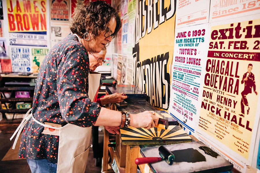woman rolling ink on a design