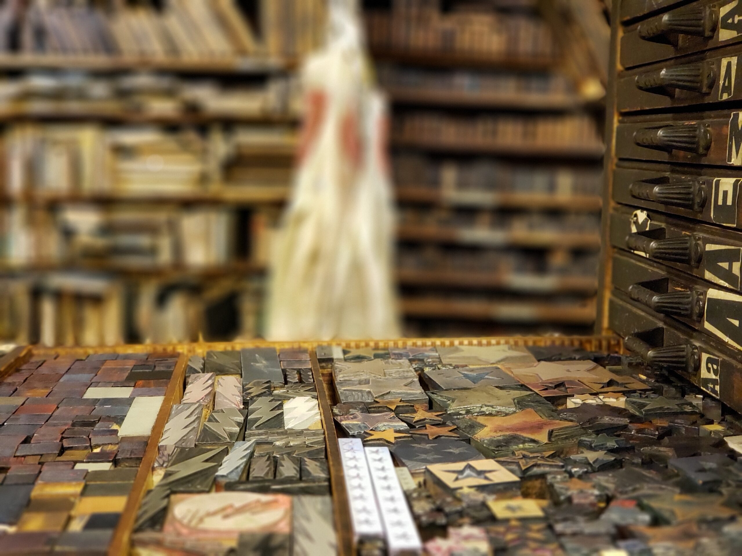 Metal letterforms and small blocks on a tray.