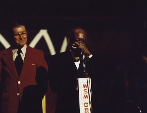 DeFord Bailey returns to the Grand Ole Opry stage with musician Roy Acuff looking on. Bailey and Acuff toured together in the 1930s and 1940s.