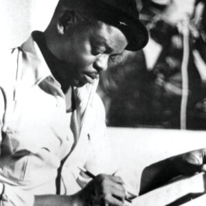 Otis Blackwell writing music in a lyric notebook