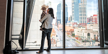 Mother and son in a cowboy hat enjoy the view from the Country Music Hall of Fame and Museum.