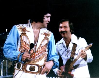 Elvis Presley performing with James Burton, c. 1976.